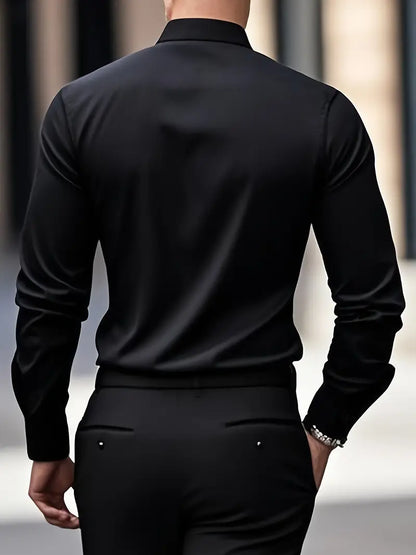 Back view of a model wearing the black shirt with black trousers, hand in pocket, showing the smooth back. 15
