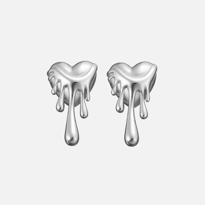 Pair of silver-tone dripping heart earrings from the front on a plain pale background 3
