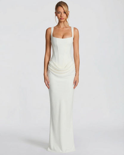Front view of the ivory dress on a model, with a seamed corset bodice, square neckline and draped hip detail. 5