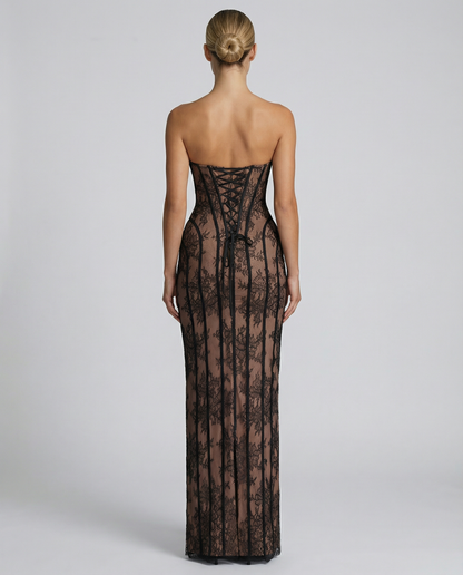Back view of the black lace dress, showing the criss-cross lacing at the corset back, a loose tie and a centre slit. 6