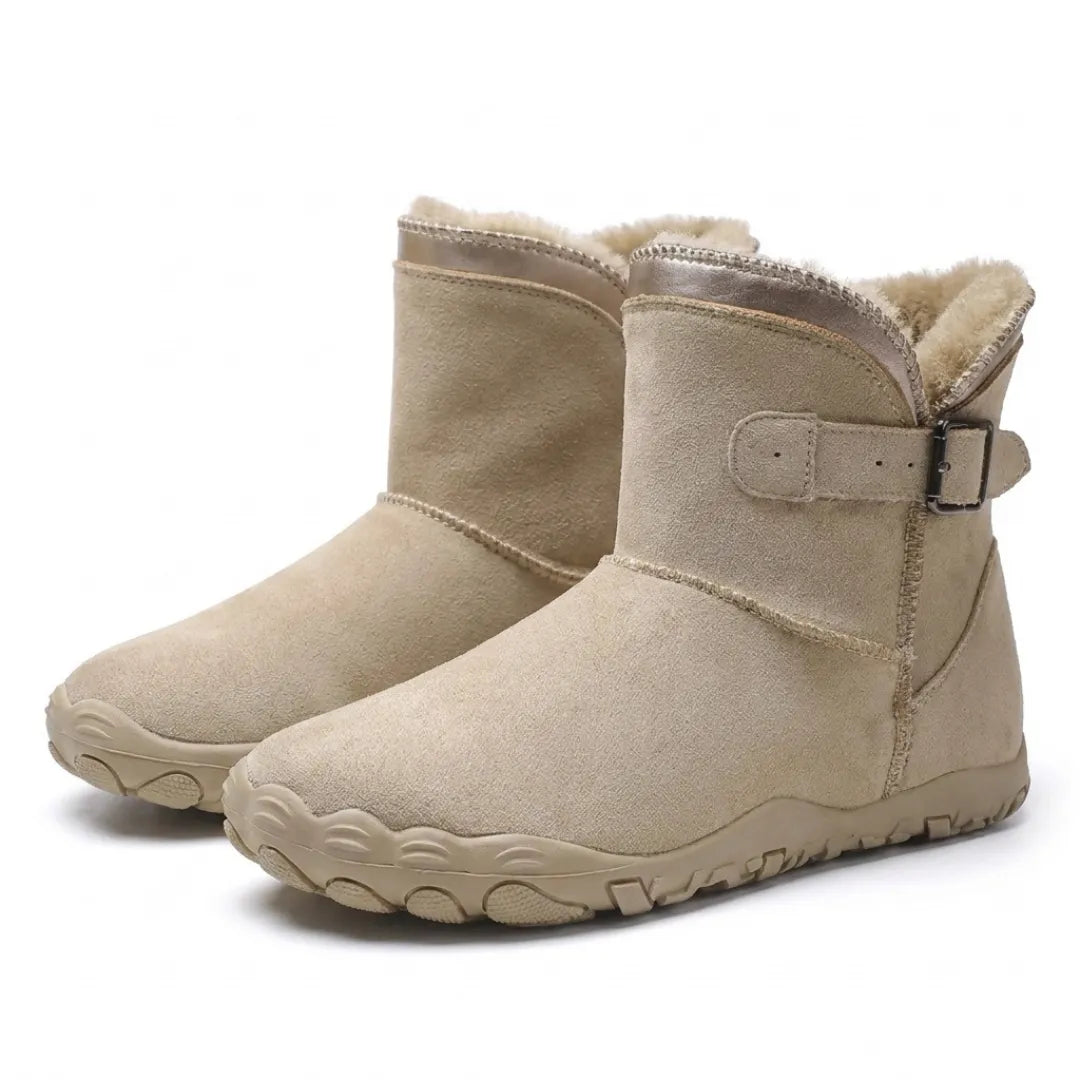 Pair of beige suede boots angled together, showing buckle straps, fleece lining and chunky sole 7