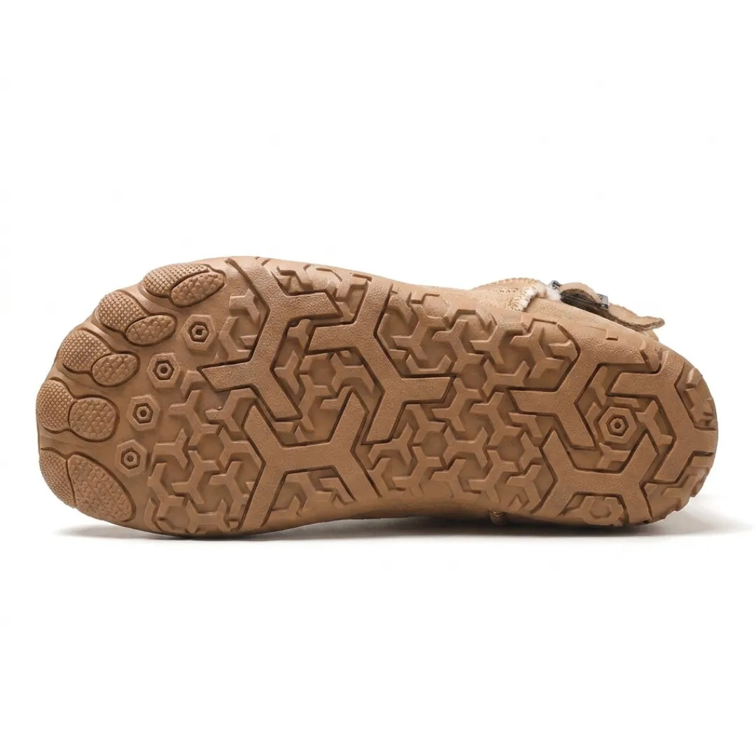 Underside of a tan boot showing the geometric tread pattern and toe-shaped sole sections 27