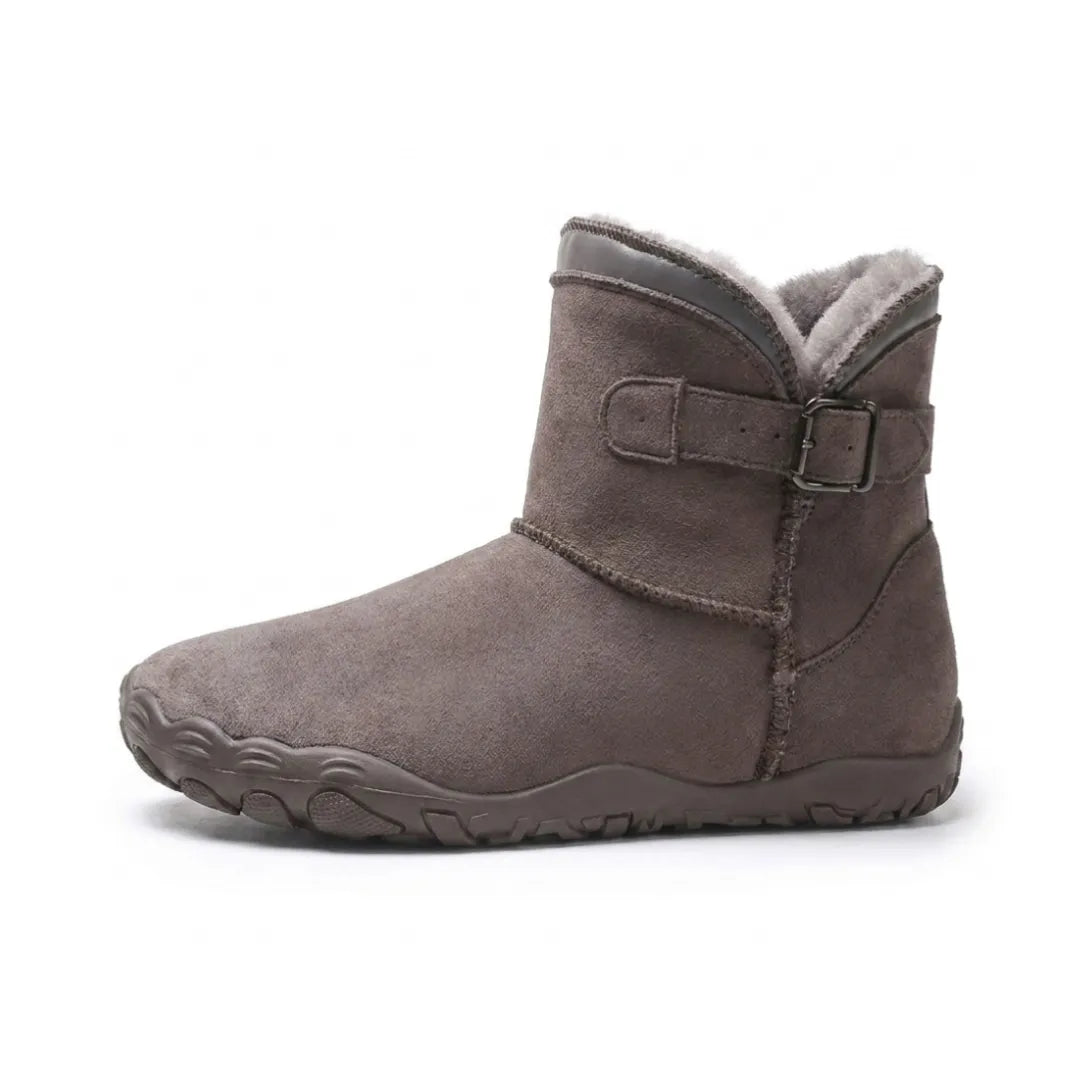 Side view of a dark taupe suede ankle boot with buckle strap and grey fleece lining 37