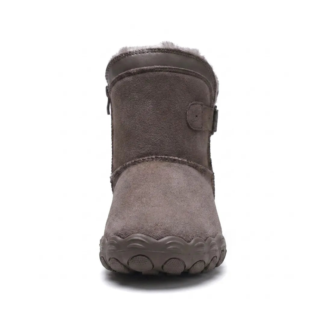 Front view of a grey-brown suede ankle boot showing the wide toe box, buckle strap and fleece lining 44