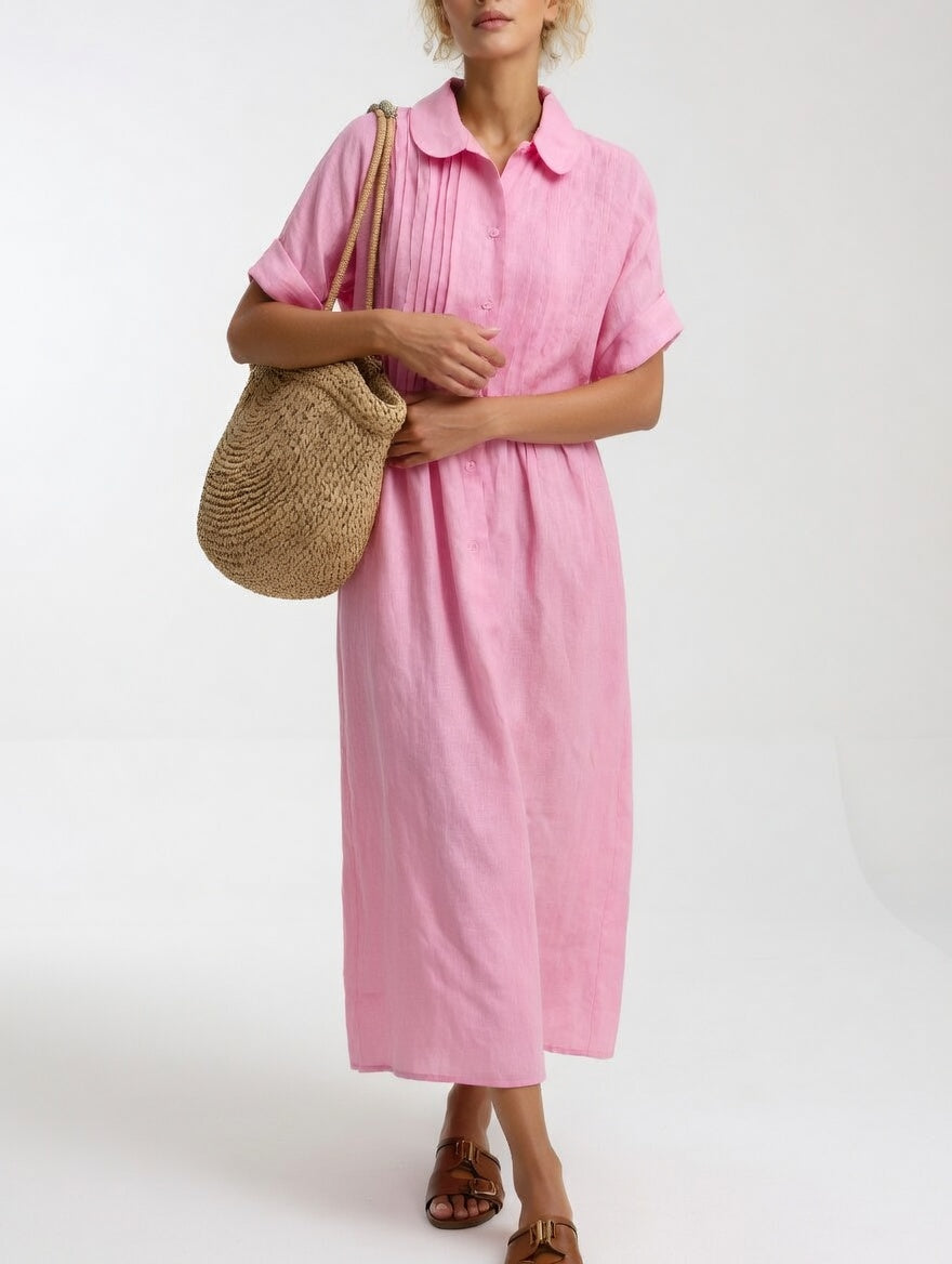 Model in the soft pink dress with a woven straw bag on her shoulder, showing pleats and rolled sleeve cuffs. 4