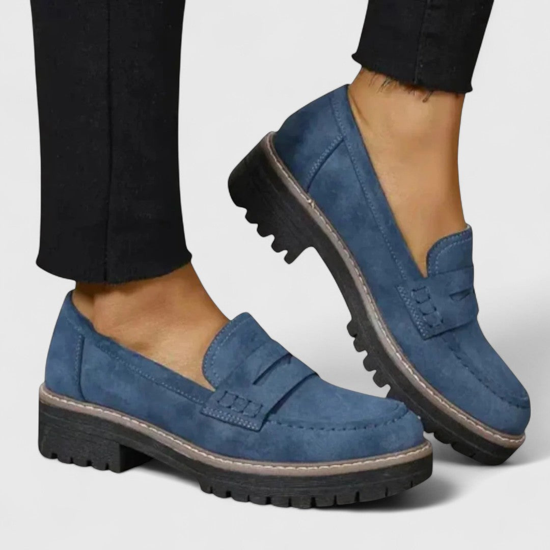 Blue suede-look loafers with chunky black soles, worn with black frayed-hem trousers 4
