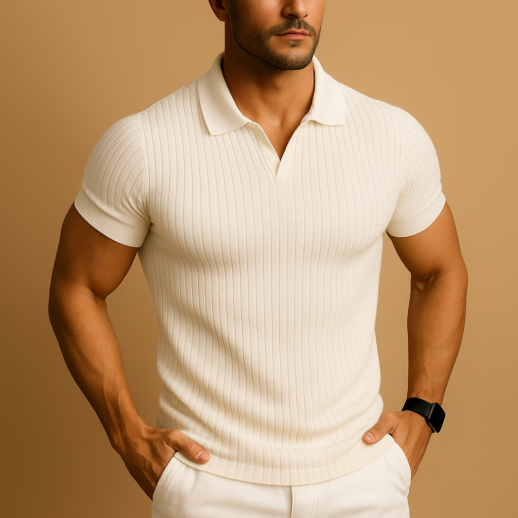 Model wearing the short-sleeved ribbed-knit polo in cream with an open V-neck collar, hands in the pockets of white trousers. 1