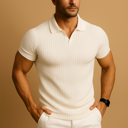 Model wearing the short-sleeved ribbed-knit polo in cream with an open V-neck collar, hands in the pockets of white trousers. 1
