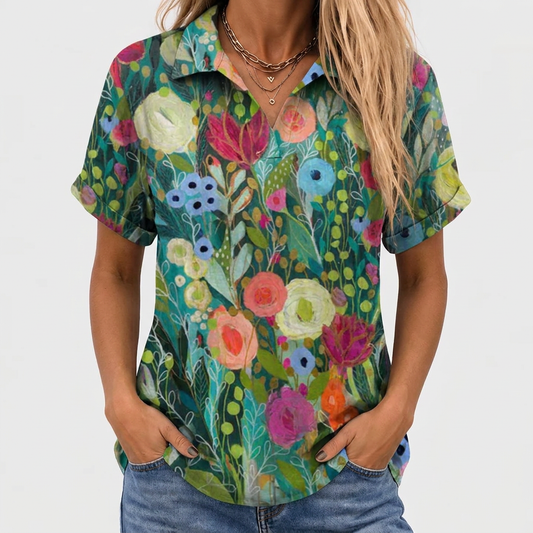 Close-up front view of the short-sleeved floral top worn with jeans, hands in pockets 1
