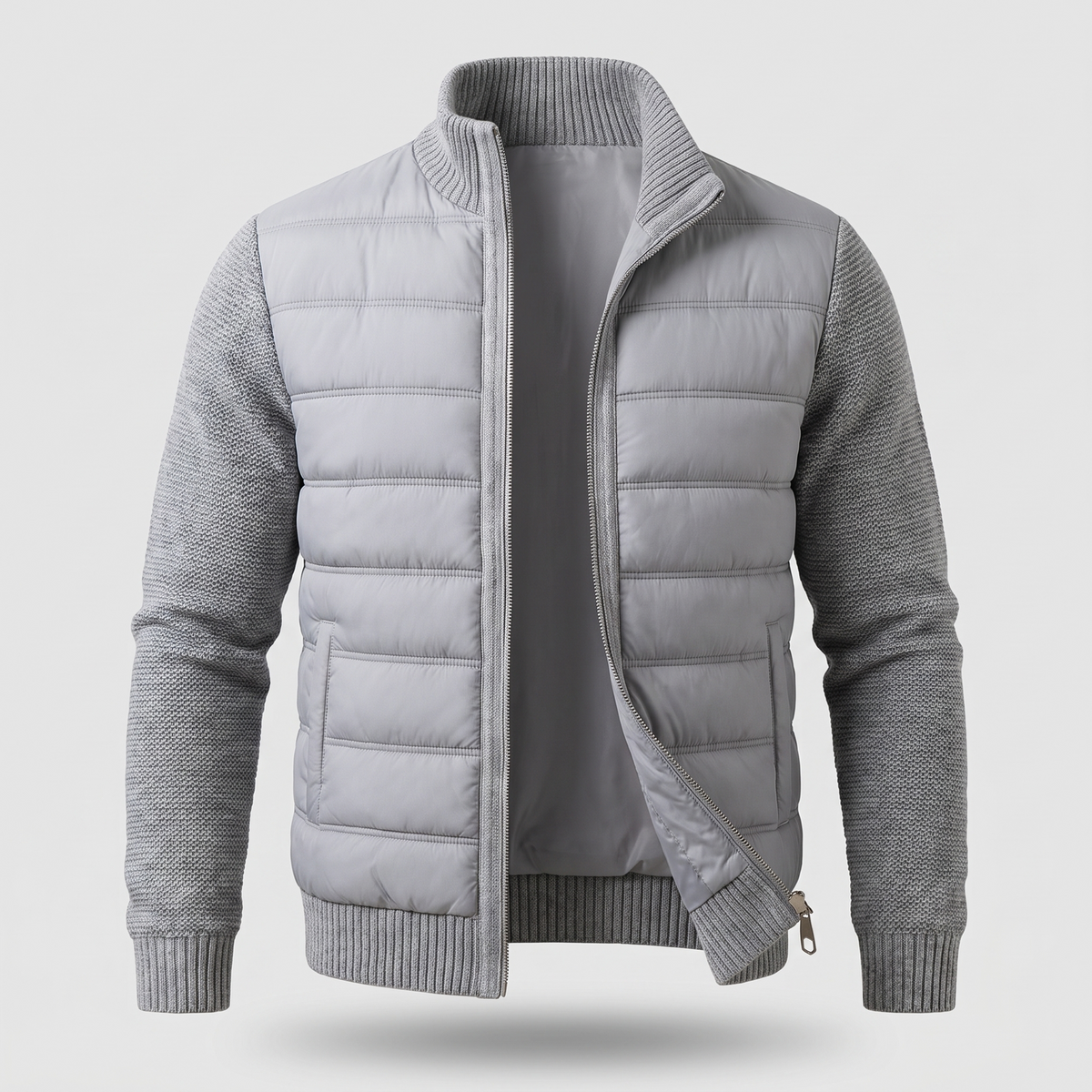 Light grey jacket laid flat from the front, unzipped, showing quilted body and ribbed knit collar and cuffs 3