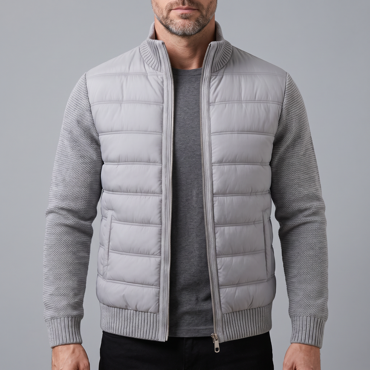 Bearded man wearing the light grey jacket unzipped over a dark grey t-shirt, front view 1