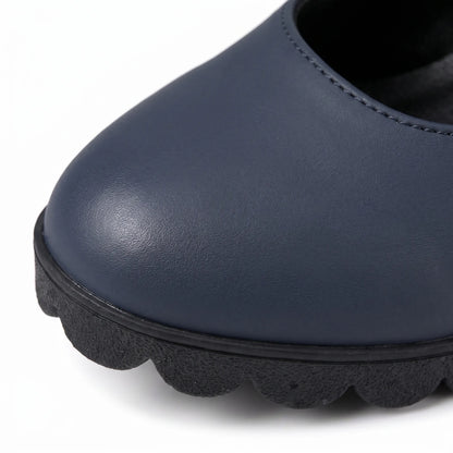 Extreme close-up of the rounded navy toe with smooth finish, black rim and scalloped ridged sole. 7