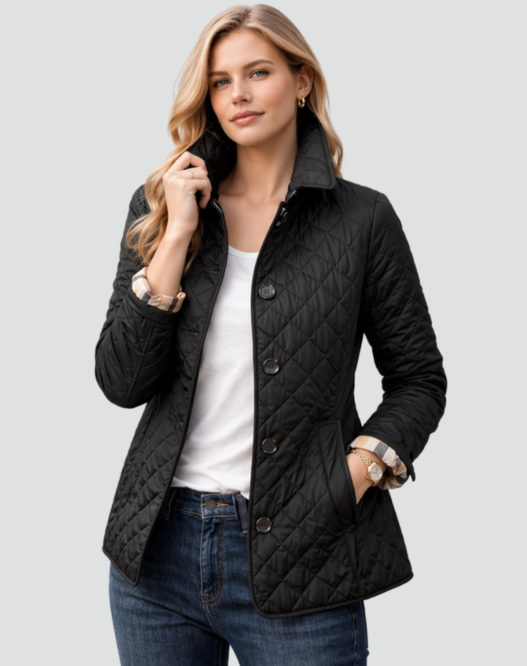 Model wearing the black diamond-quilted jacket buttoned over a white tee and jeans, one hand in the pocket, check cuff turned back. 1