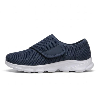 Navy mesh shoe with a wide hook-and-loop strap and white sole, side view 1