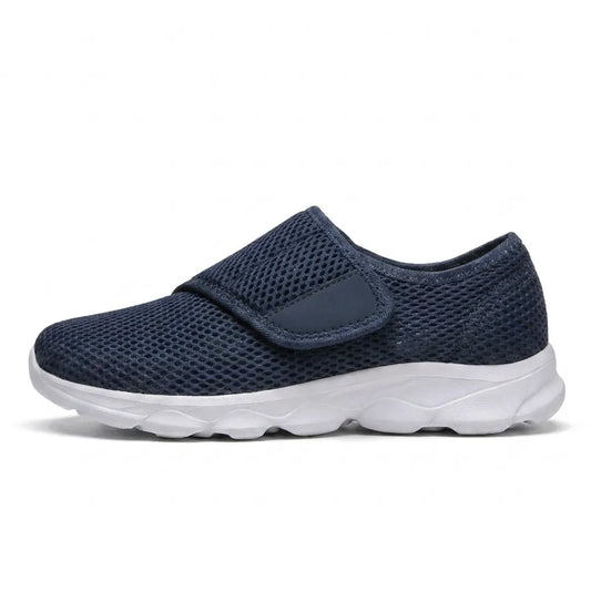 Navy mesh shoe with a wide hook-and-loop strap and white sole, side view 1
