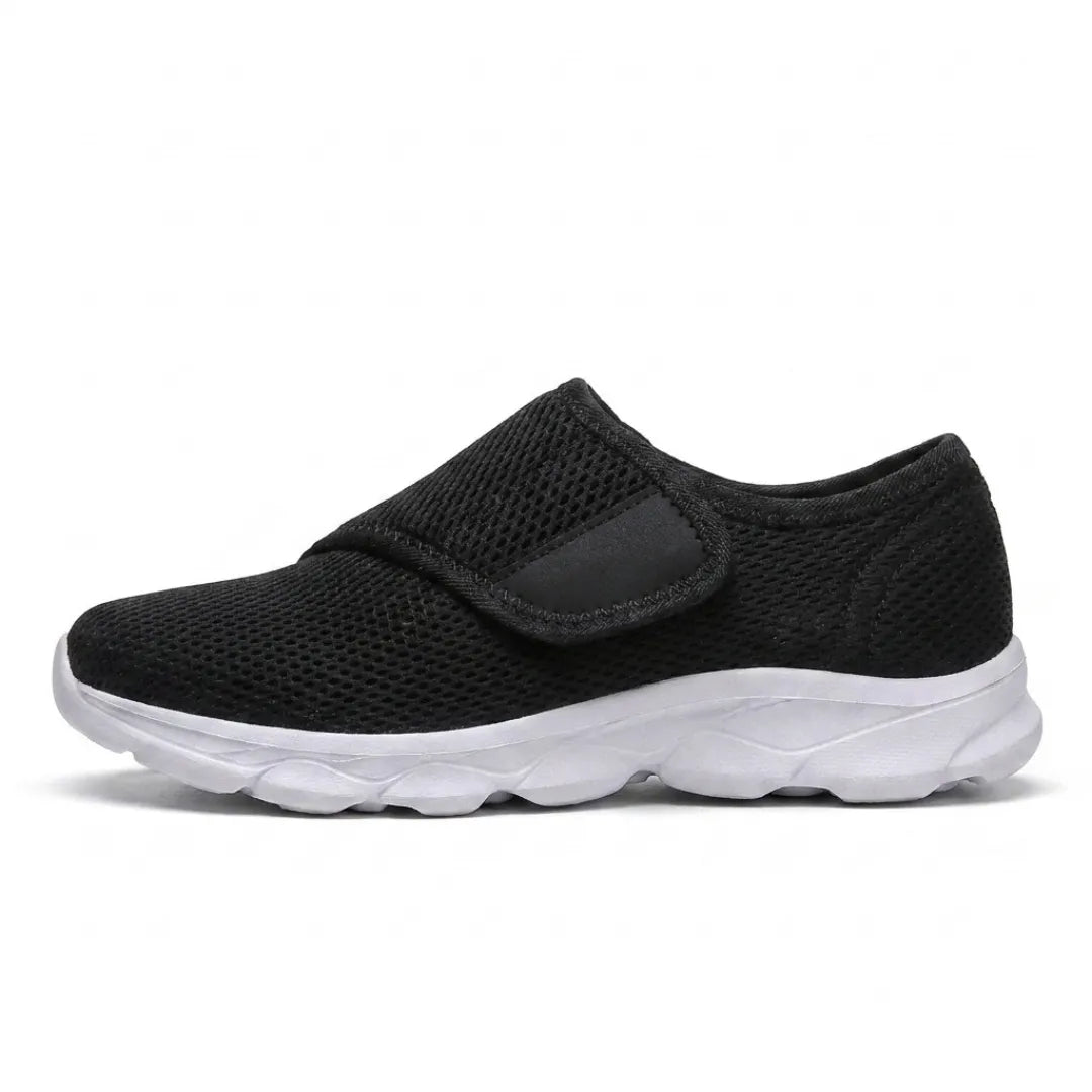 Black mesh shoe with a white sole and wide hook-and-loop strap, side view 19