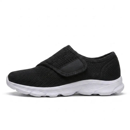 Black mesh shoe with a white sole and wide hook-and-loop strap, side view 19