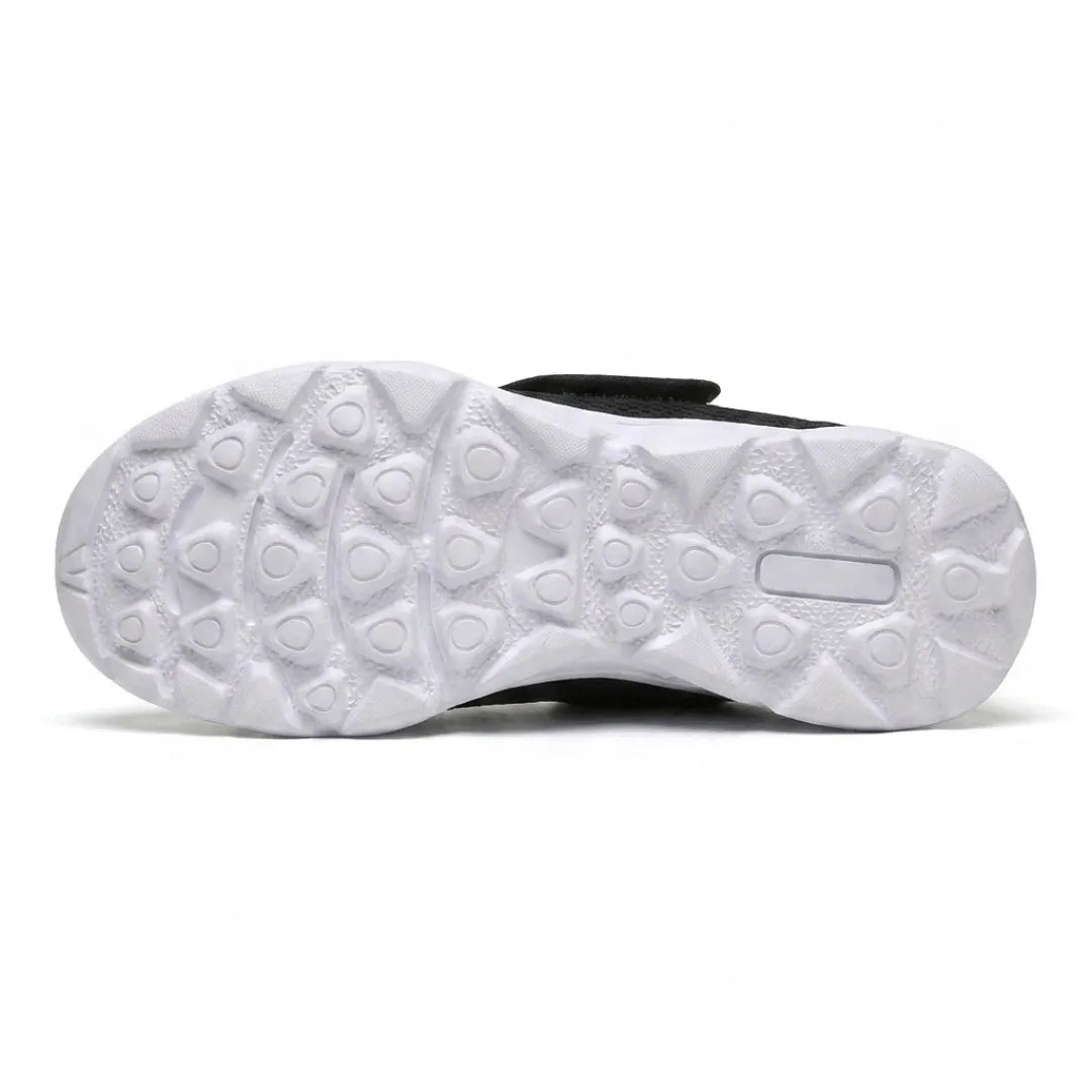 Underside of the white sole showing the triangular tread pattern, with the black upper edge visible 27