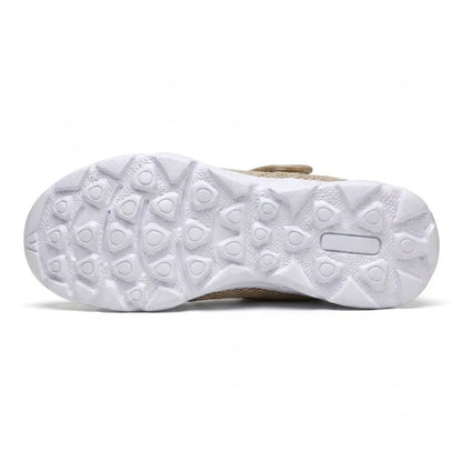 Underside of the white sole showing the triangular tread pattern, with the beige upper edge visible 36