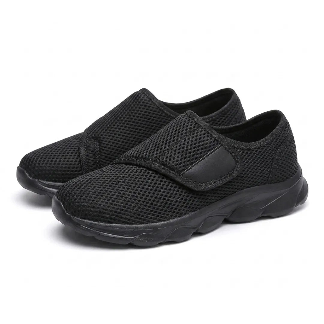 Pair of all-black mesh hook-and-loop shoes, angled three-quarter view 16