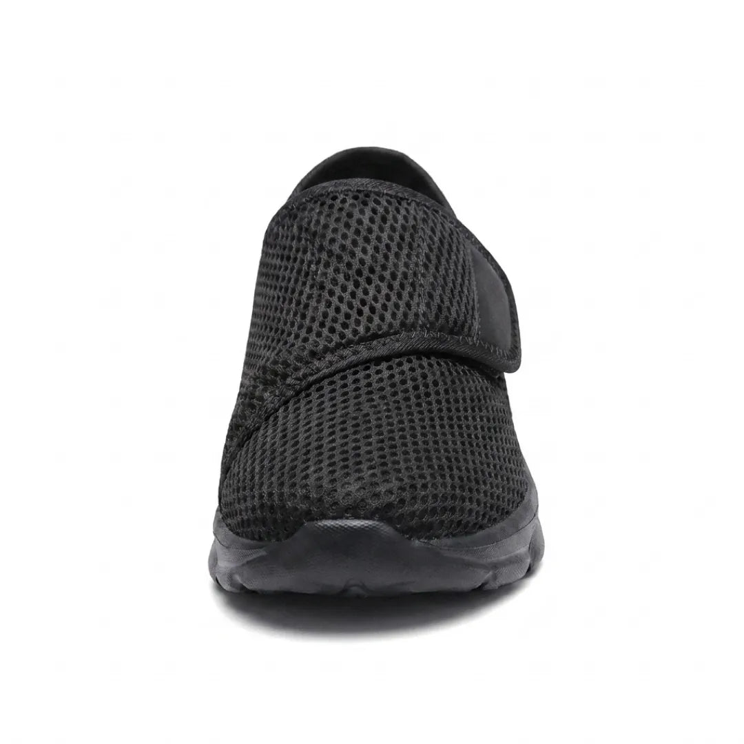 All-black mesh shoe seen from the front, showing the rounded toe and strap 17