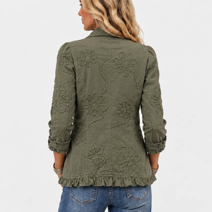 Back view of the olive green jacket showing large embroidered flowers and a ruffled hem 5