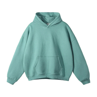 Front view of a plain teal-green hoodie laid flat, showing the hood, drop shoulders, ribbed cuffs and large front pouch pocket. 7