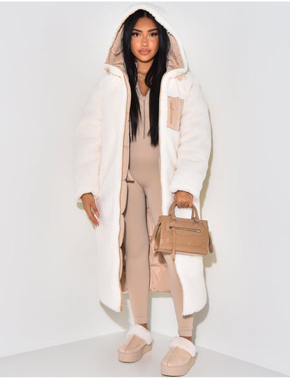Reversed to the cream teddy-fleece outer side, worn open with the hood up, showing a beige quilted lining and a zipped chest pocket. 4