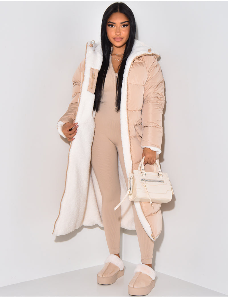 Beige quilted side worn open, showing the white fleece lining, hood and cuffs, styled with a beige jumpsuit and cream handbag. 5
