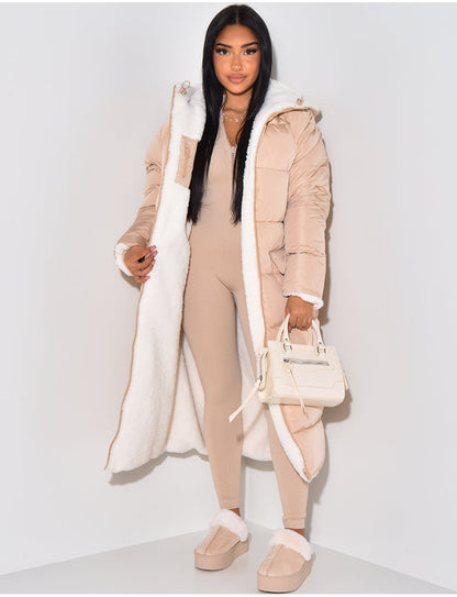 Beige quilted side worn open, showing the white fleece lining, hood and cuffs, styled with a beige jumpsuit and cream handbag. 5