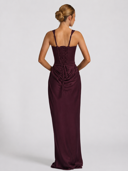 Back view of the plum dress showing adjustable straps, a lace-up corset back with long ties and the ruched skirt below. 14