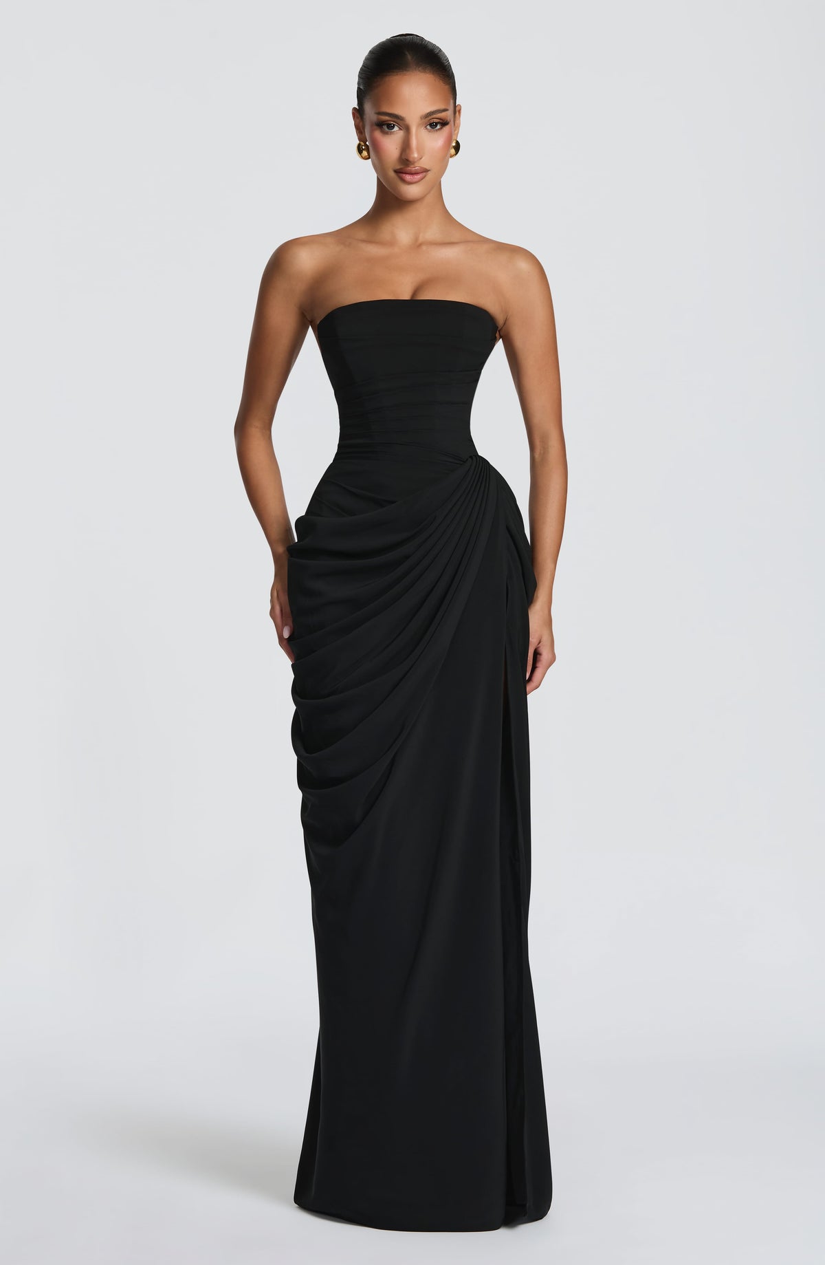 Front view of the black strapless maxi dress, showing the ruched corset bodice and draped skirt gathered at one hip. 31