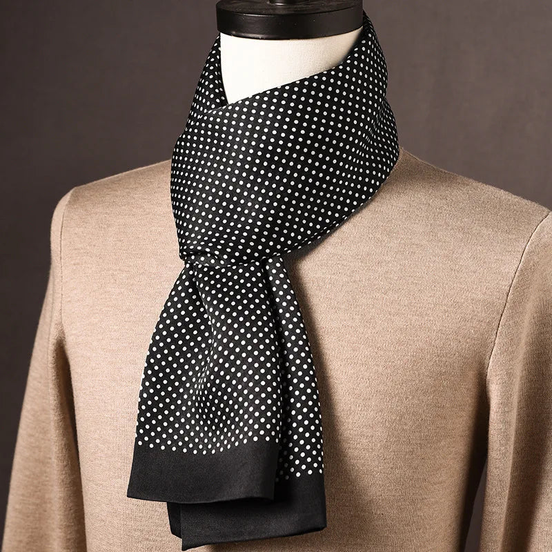Black silk scarf with small white polka dots and plain black ends, draped on a mannequin over a beige jumper. 14