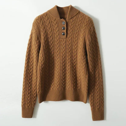 Flat lay of the caramel-brown cable-knit sweater on a pale background, showing the ribbed collar, three buttons and ribbed cuffs. 17