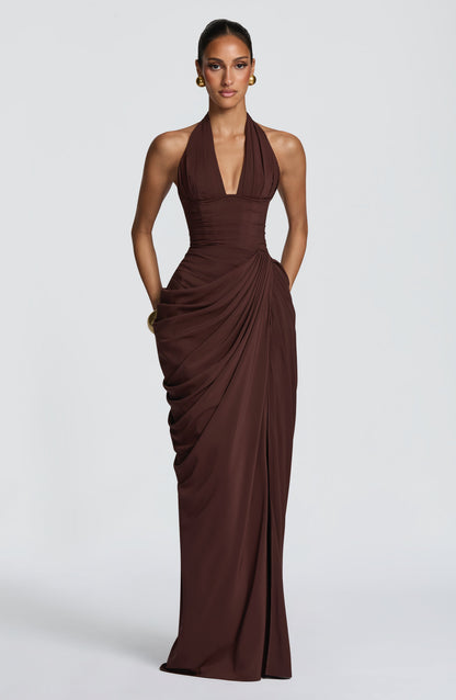 Front view of the brown halter maxi dress, with pleated plunging bodice, corset waist and side-draped skirt. 26