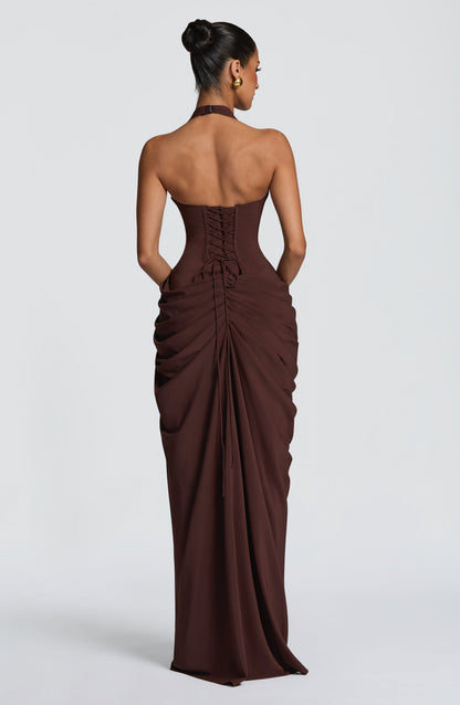 Back view of the brown dress, showing the corset lacing and the ruched, gathered skirt with long trailing ties. 25