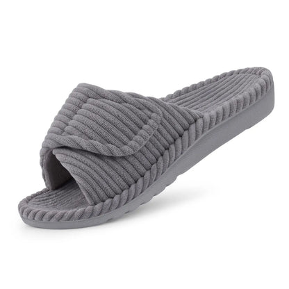 Single grey ribbed open-toe slide slipper with a folded-over adjustable strap, seen at a three-quarter angle on a white background. 1