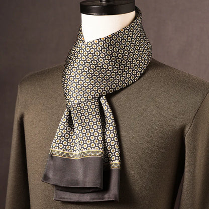 Dark silk scarf with a small cream and gold medallion print, a patterned border and plain grey ends, draped on a mannequin. 7