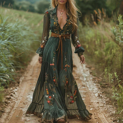 Model walking along a country track in the dark green maxi dress, tied with a tan leather belt 1