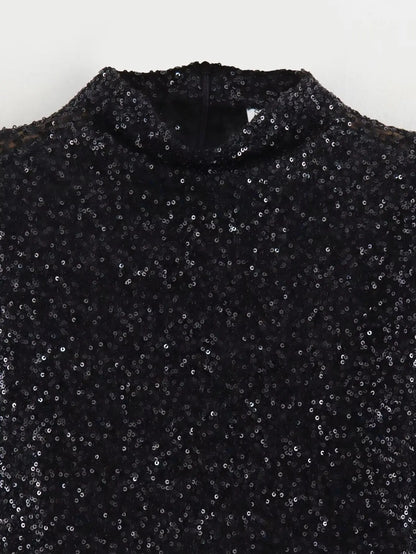 Close-up flat view of the black sequin fabric at the neckline and shoulders of the dress 4