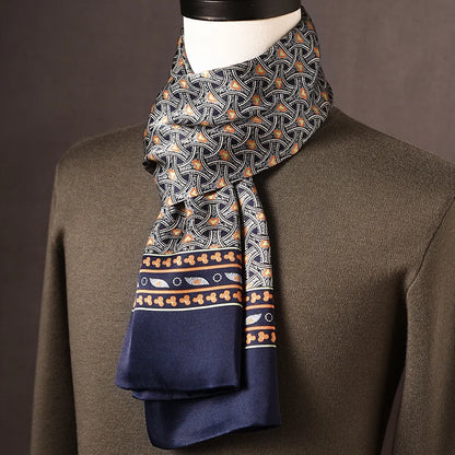 Navy silk scarf with an interlocking arch pattern in orange and white, a patterned border and plain navy ends, draped on a mannequin. 11