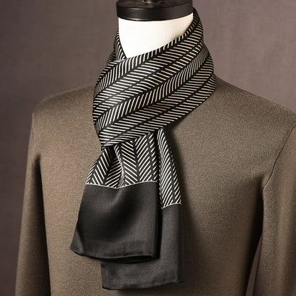 Black and cream herringbone-striped silk scarf with plain black ends, draped on a mannequin over an olive jumper. 4