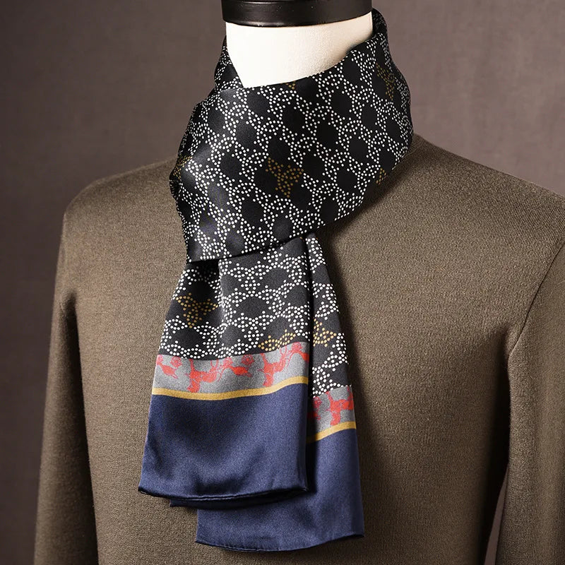 Black silk scarf with a white dotted pattern, a grey border with red deer motifs and plain navy ends, draped on a mannequin. 16