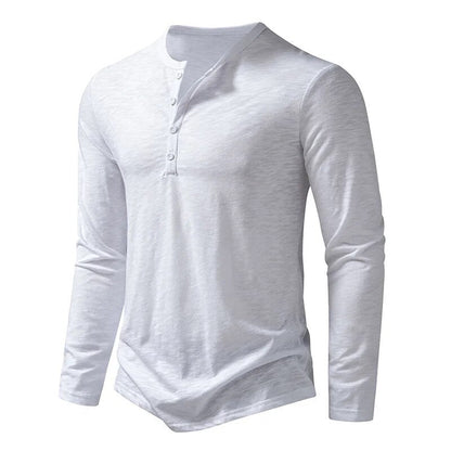 White long-sleeved henley photographed at an angle, showing the buttons and slim cut 10