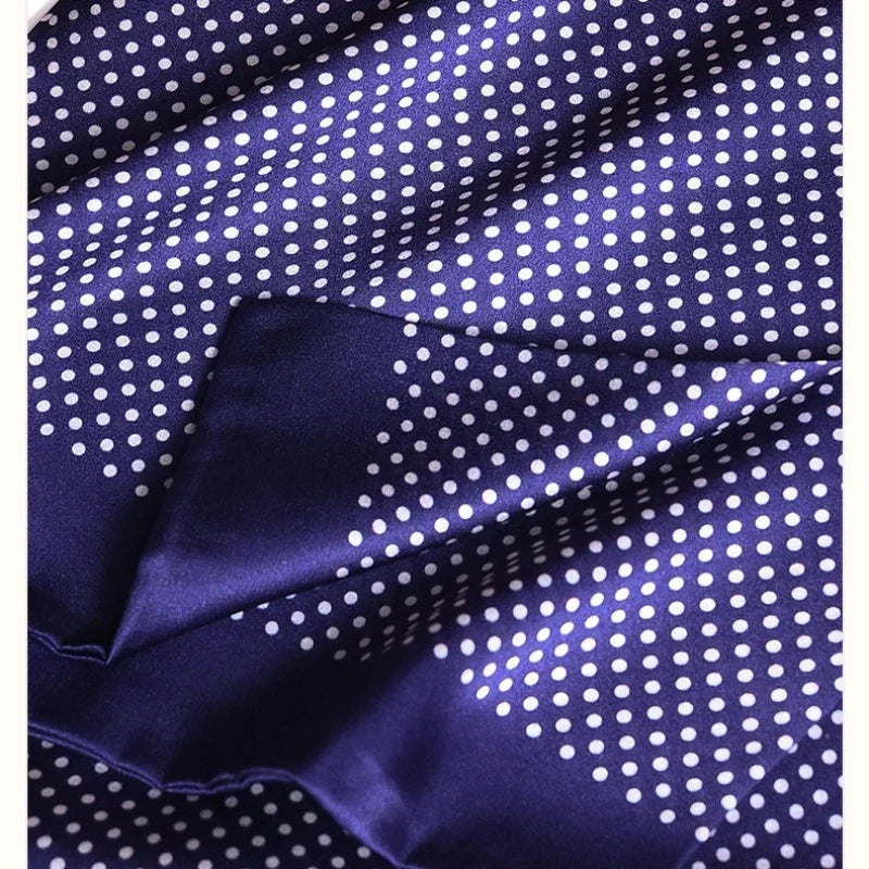 Close-up of the navy silk fabric with white polka dots, showing its smooth sheen and a folded edge. 27
