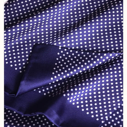 Close-up of the navy silk fabric with white polka dots, showing its smooth sheen and a folded edge. 27