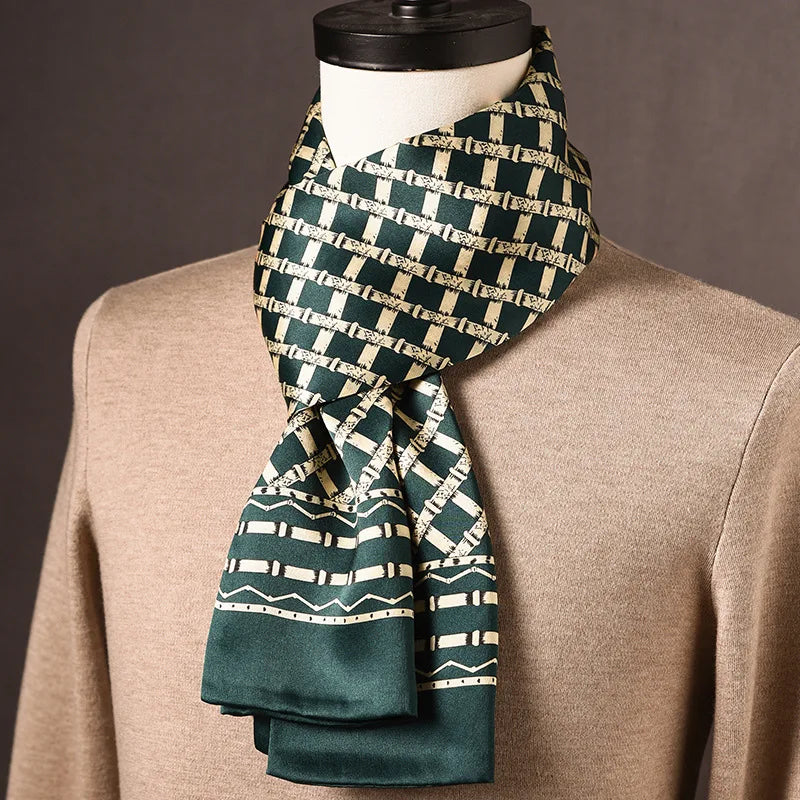 Dark green silk scarf with a cream bamboo-style lattice pattern and a zigzag border, draped on a mannequin over a beige jumper. 19