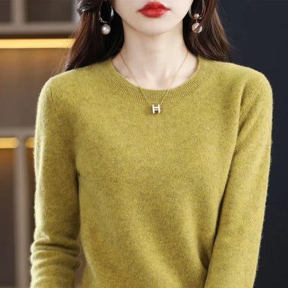 Close-up of a mustard-green crew-neck jumper on a model, showing the soft knit and ribbed collar 1