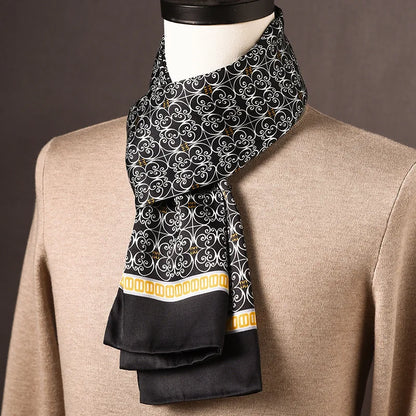 Black silk scarf with a white scrollwork pattern and a yellow and white patterned border, draped on a mannequin. 25