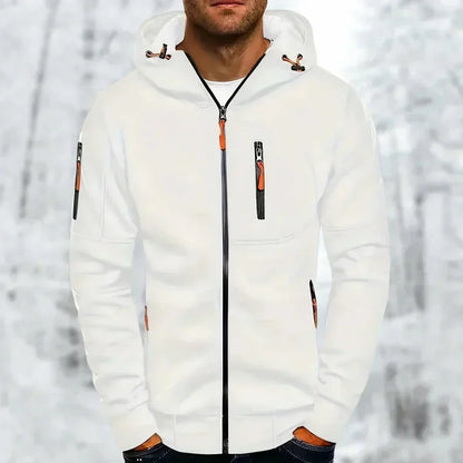 Model wearing the zip-up hoodie in white with orange zip pulls and a black front zip, against a snowy backdrop. 3